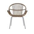 A grey wash natural rattan chair with a rounded backrest and slender vertical slats, supported by sleek metal legs. The chair features a comfortable, open design suitable for various home settings