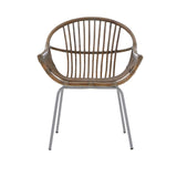 A grey wash natural rattan chair with a rounded backrest and slender vertical slats, supported by sleek metal legs. The chair features a comfortable, open design suitable for various home settings