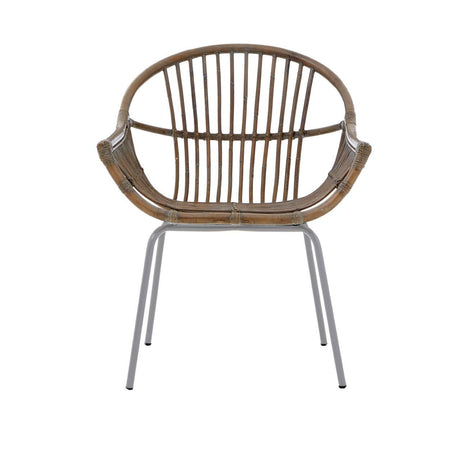A grey wash natural rattan chair with a rounded backrest and slender vertical slats, supported by sleek metal legs. The chair features a comfortable, open design suitable for various home settings