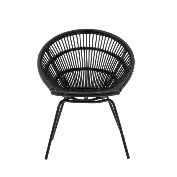 A round black rattan chair with a woven design and slender iron legs, showcasing a modern and minimalist style. The chair features a deep seat and an open back, emphasizing its airy and contemporary look