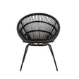 A round black rattan chair with a woven design and slender iron legs, showcasing a modern and minimalist style. The chair features a deep seat and an open back, emphasizing its airy and contemporary look