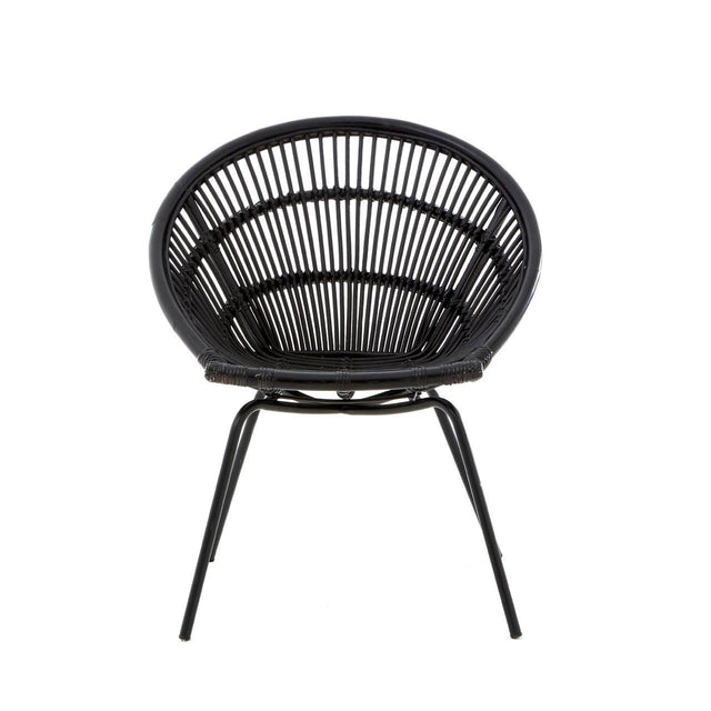 A round black rattan chair with a woven design and slender iron legs, showcasing a modern and minimalist style. The chair features a deep seat and an open back, emphasizing its airy and contemporary look