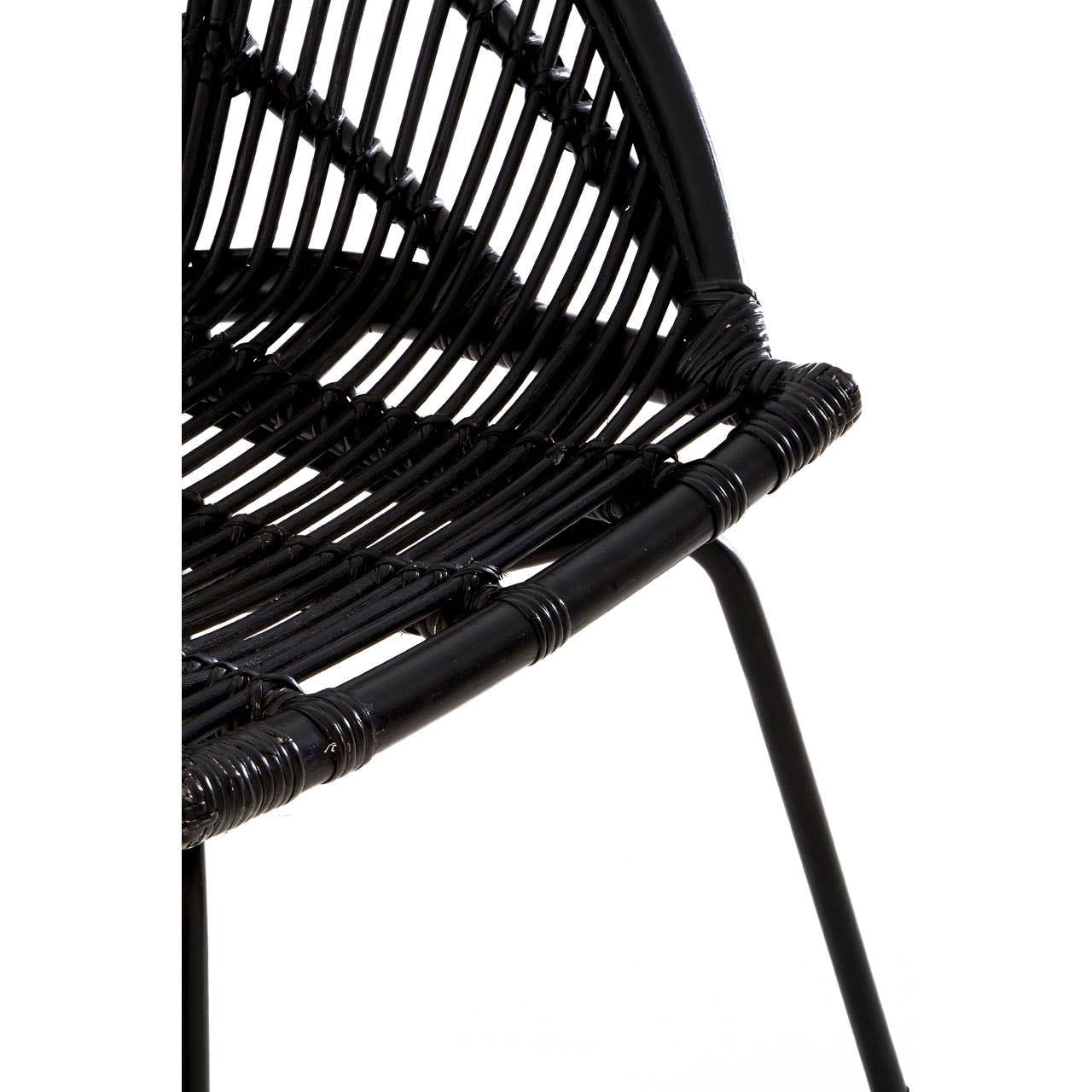 Black natural rattan chair featuring a curved seat design and slender iron legs, showcasing a modern and minimalist aesthetic. The woven rattan pattern is visible, emphasizing its texture and craftsmanship