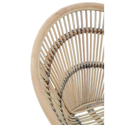 A close-up view of a white washed natural rattan chair, showcasing its curved backrest and intricate woven design, highlighting the light, airy aesthetic of the material
