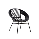A black chair featuring a round, open design made of natural rattan and iron, with a sleek black finish. The chair has a curved backrest and slender legs, showcasing a modern and minimalist aesthetic