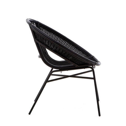 A side view of a black chair featuring a natural rattan seat and a sturdy iron frame, showcasing a modern design with a curved backrest and sleek legs