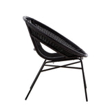 A side view of a black chair featuring a natural rattan seat and a sturdy iron frame, showcasing a modern design with a curved backrest and sleek legs