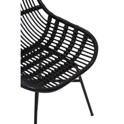 Curved black rattan chair featuring a sleek, open-weave design with a modern aesthetic, supported by slender black metal legs. The chair's shape emphasizes comfort and style, making it suitable for various home decor settings