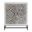 Rustic two-door cabinet featuring a chevron pattern in earthy tones, set on a sleek black metal base. The cabinet has a textured surface with a geometric design, providing a stylish storage solution for home decor