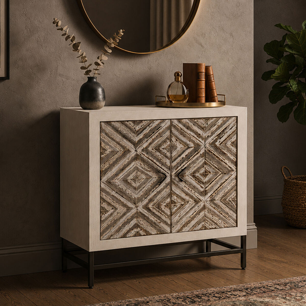 Rustic two-door cabinet featuring a chevron pattern on the front, set against a light-colored frame. The cabinet is elevated on black metal legs and includes a round mirror above it, with decorative items like a vase and books placed on top. The background has a textured wall and a hint of greenery from a nearby plant