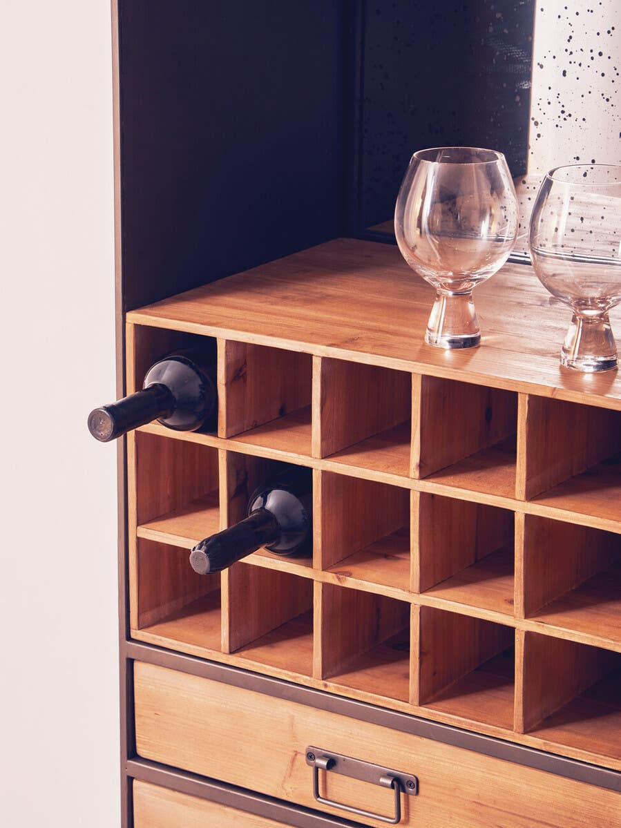 Wooden bar cabinet featuring a top section with multiple square compartments for storing bottles, two black handles, and a smooth wooden surface. A glass and decorative items are placed on top, showcasing a stylish and functional design