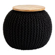 A round black knitted pouffe with a textured surface and a light wooden top, suitable for use as a stool or side table