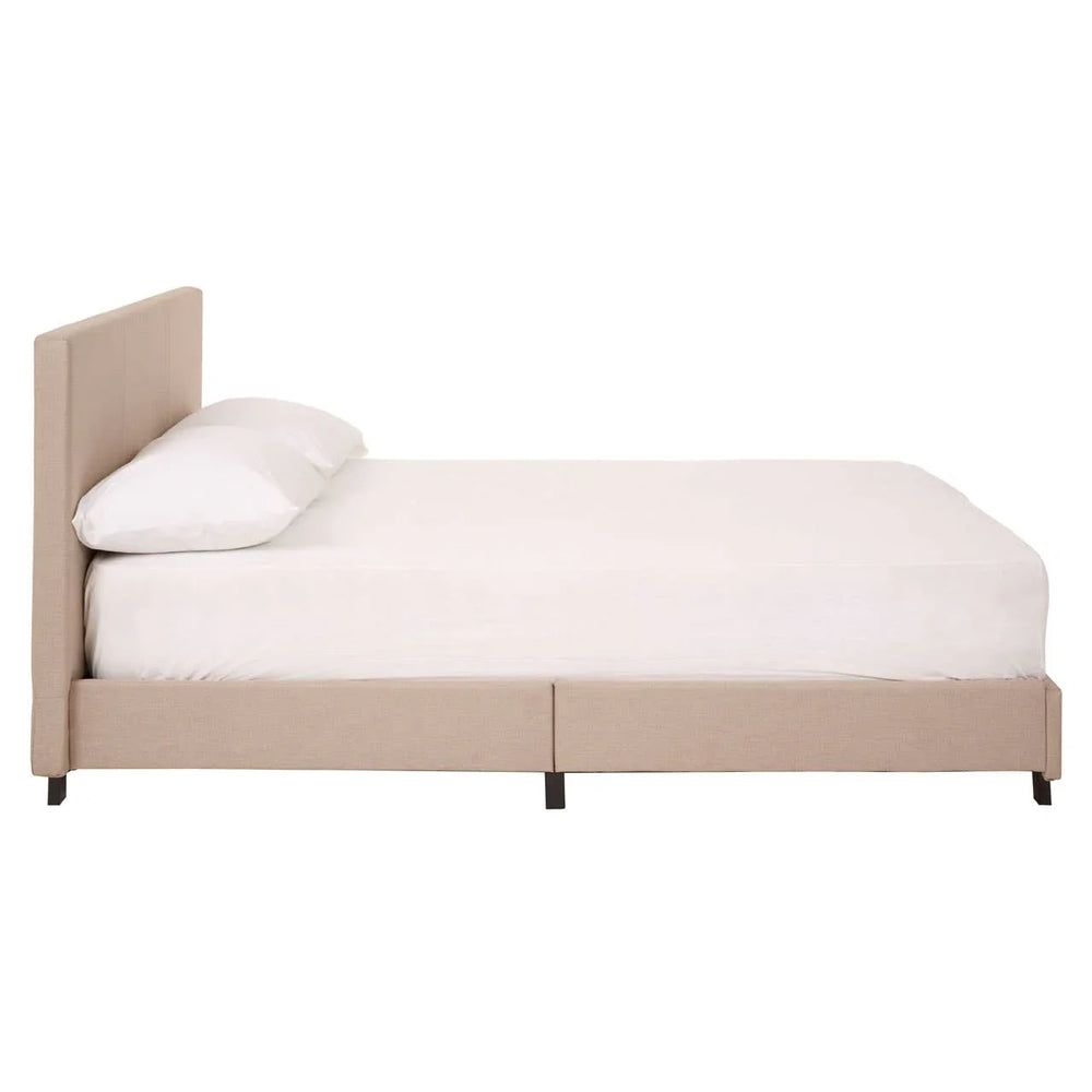 Beige upholstered bed frame with low headboard and white bedding, side profile view