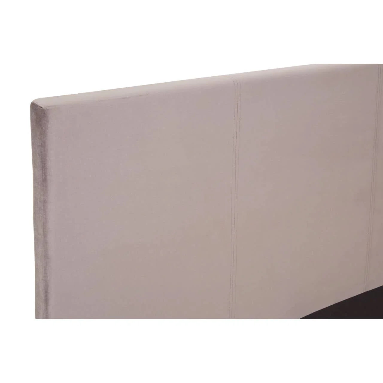 Beige upholstered bed headboard with stitched panel detail, angled view