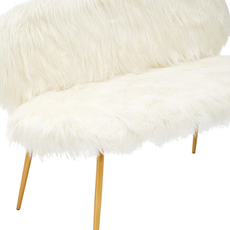 A two-seat sofa featuring a plush white faux fur upholstery with a rounded backrest and soft seating surface, supported by sleek gold finish legs. The design is modern and elegant, ideal for contemporary home decor