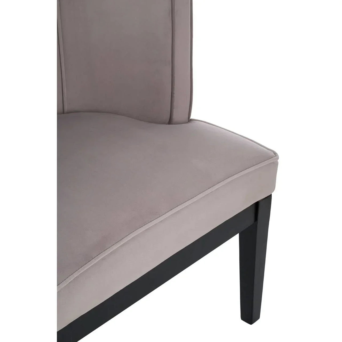 Close-up of grey fabric dining chair seat with black wooden legs