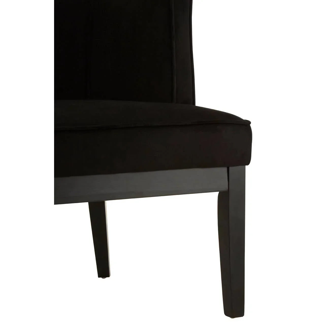 Closeup of black velvet dining chair seat and wooden legs