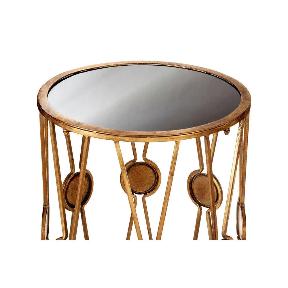 Round side table with gold metal frame and black glass top, decorative circular accents