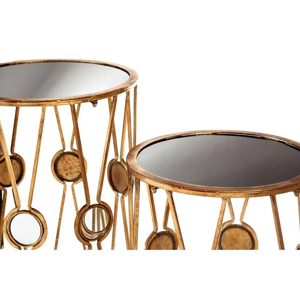 Gold metal side tables with black mirrored tops and circular accents, close view