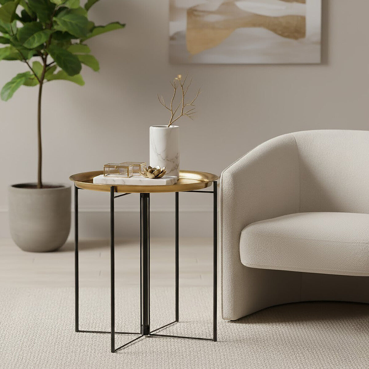 A large side table featuring a brass and black finish, with a wooden top and sleek metal legs, positioned next to a light-colored armchair and a potted plant in a modern living space. A white vase and decorative items are placed on the table's surface