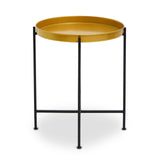 Small side table featuring a round brass tray top and a sleek black metal frame with four legs, designed for modern home decor