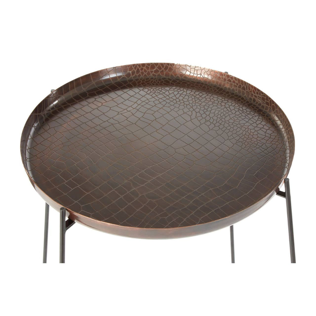 Round side table featuring a copper finish with a crocodile texture on the surface, complemented by slender black legs. The table has a raised edge and a smooth, patterned top, ideal for decorative items or drinks