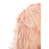 Soft pink faux fur texture of a kids chair, showcasing fluffy fibers that create a cozy and inviting appearance. The chair's design is perfect for a child's room, emphasizing comfort and style