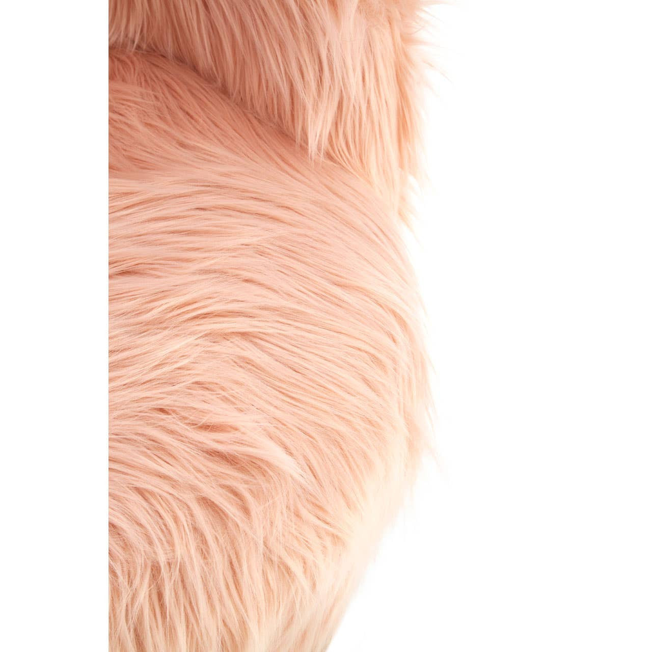 Soft pink faux fur covering a cozy chair, showcasing a fluffy texture that invites comfort. The chair's design features rounded edges and a plush appearance, perfect for a child's room