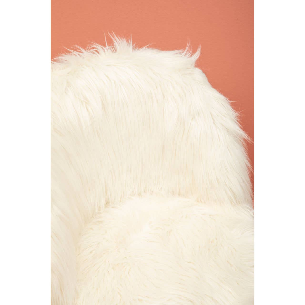 Soft white faux fur chair with a fluffy texture, set against a warm peach background. The chair features rounded edges and a cozy appearance, ideal for a child's room