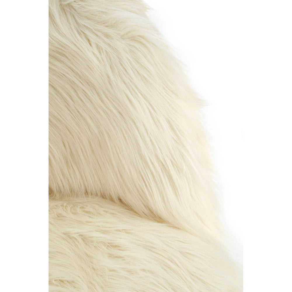 Soft white faux fur texture of a kids' chair, showcasing a cozy and plush appearance. The chair features a rounded back and is designed for small children, emphasizing comfort and style