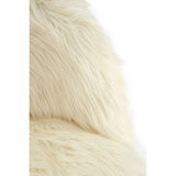 Soft white faux fur texture of a kids' chair, showcasing a cozy and plush appearance. The chair features a rounded back and is designed for small children, emphasizing comfort and style