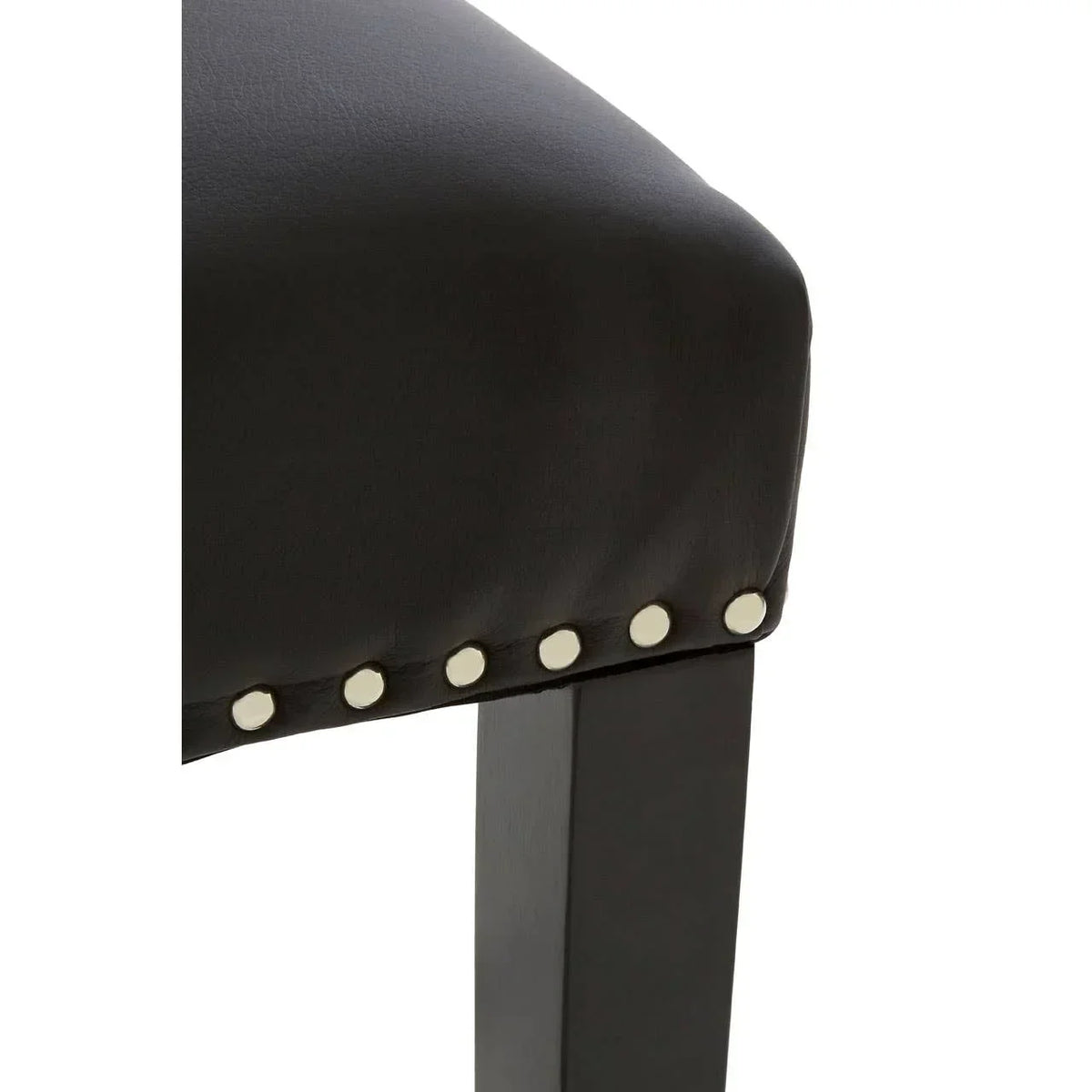 Black leather dining chair seat with silver stud detailing and wooden leg closeup