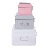 Set of three metal storage trunks in pink, grey, and white stacked vertically