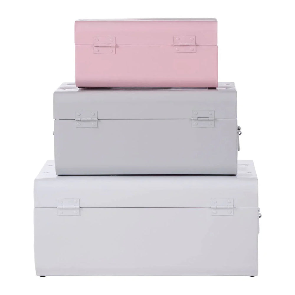 Set of three metal storage trunks in pastel pink and grey, stacked in size order