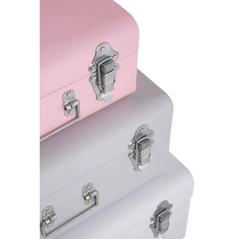 Stacked pink and grey metal storage trunks with silver latches and handles