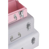 Stacked metal storage trunks in pink and grey with chrome handles and latches