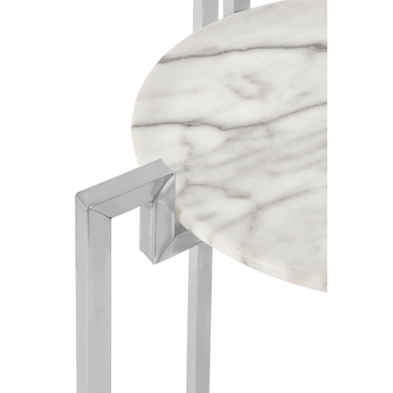 Close-up view of a round white marble side table featuring a sleek chrome base, highlighting the smooth surface of the marble and the modern design of the metal frame