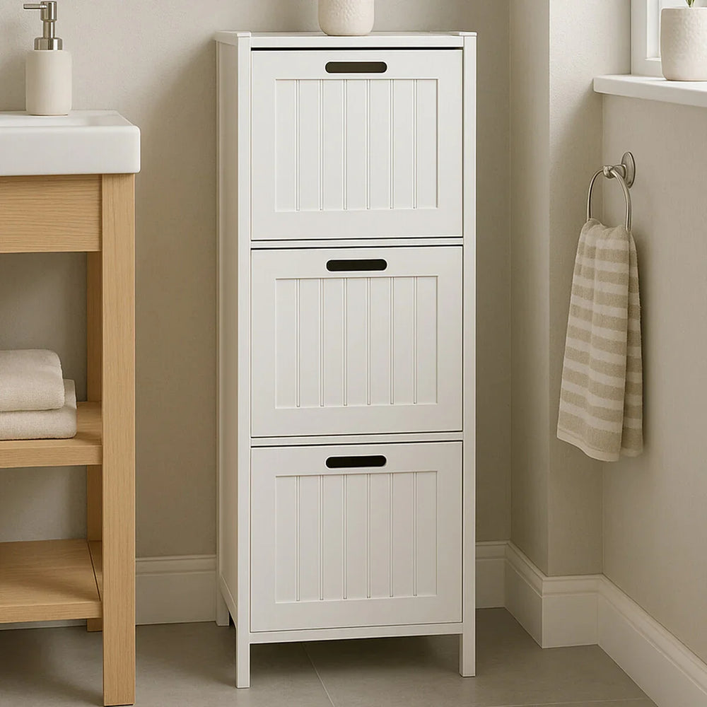 White bathroom storage unit with three panelled drawers next to washbasin and striped towel