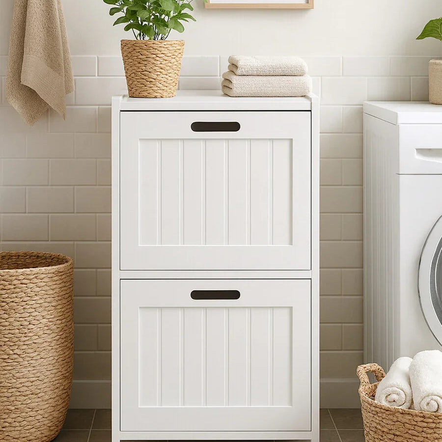White laundry cabinet with panelled doors, wicker basket and potted plant in utility room