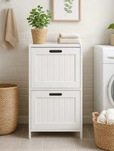 White laundry cabinet with panelled doors, wicker basket and potted plant in utility room