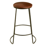 A sleek bar stool featuring a round faux leather seat in a warm brown tone, supported by slender metal legs with a matte finish. The stool includes a footrest for added comfort and has a minimalist design suitable for modern home decor