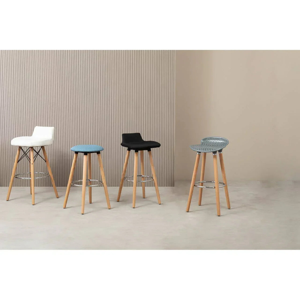 Modern breakfast bar stools with wooden legs in assorted colors against neutral wall background