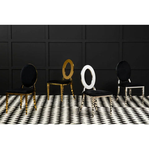Modern dining chairs with black velvet seats, gold and chrome oval backs, on checkered floor