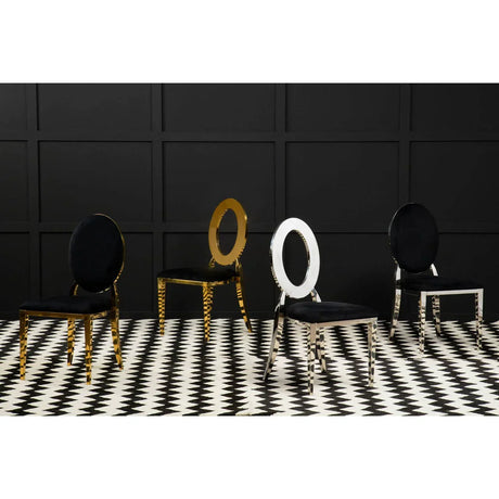 Modern dining chairs with black velvet seats, gold and chrome oval backs, on checkered floor