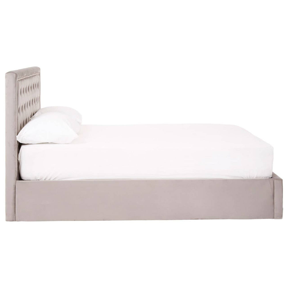 Grey velvet double ottoman bed with a tufted headboard and a white mattress, featuring a storage compartment underneath. The bed is positioned against a plain background, showcasing its elegant design and soft texture