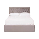 Double bed with a grey velvet upholstered headboard featuring button tufting, complemented by a matching grey velvet base. The bed is styled with a white mattress and bedding, creating a clean and modern look