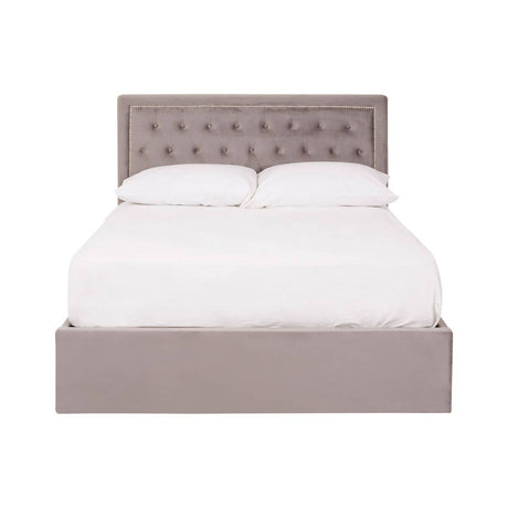 Double bed with a grey velvet upholstered headboard featuring button tufting, complemented by a matching grey velvet base. The bed is styled with a white mattress and bedding, creating a clean and modern look