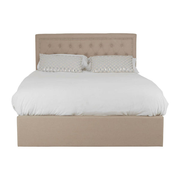 Beige upholstered double bed with a tufted headboard, featuring a white duvet and two matching pillows, designed with an ottoman storage base