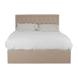 Beige upholstered double bed with a tufted headboard, featuring a white duvet and two matching pillows, designed with an ottoman storage base