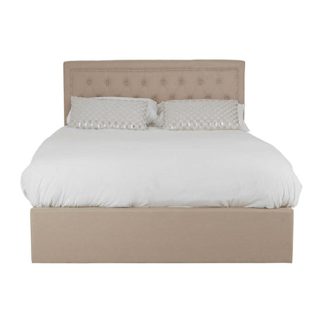 Beige upholstered double bed with a tufted headboard, featuring a white duvet and two matching pillows, designed with an ottoman storage base